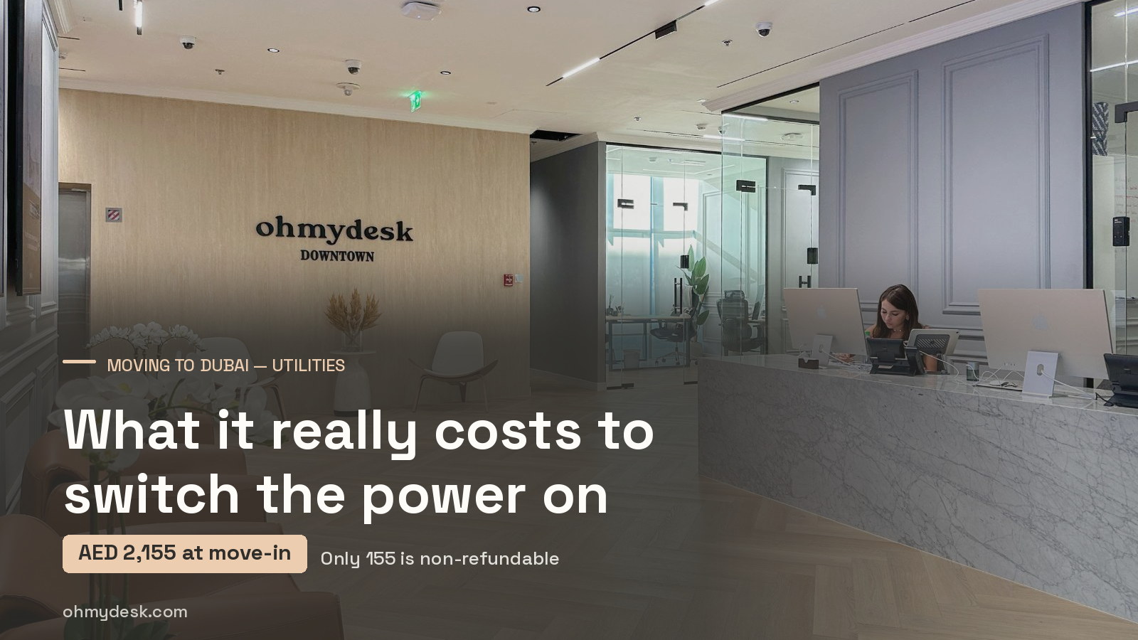Reception counter at Oh My Desk Downtown Dubai, where members handle move-in paperwork such as DEWA activation documents