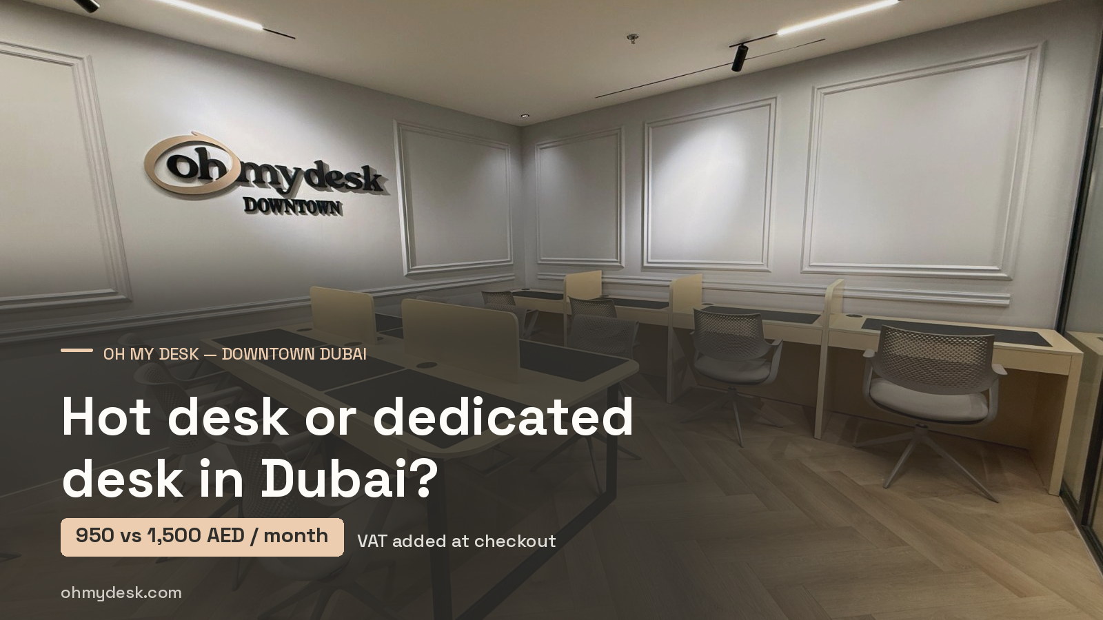 Reserved desks with individual desk mats under the Oh My Desk Downtown wall sign, illustrating a guide comparing a Dubai hot desk at 950 AED with a dedicated desk at 1,500 AED a month