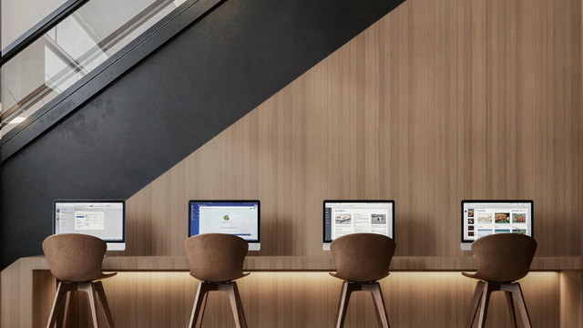 Workstations with screens at Oh My Desk Downtown Dubai, illustrating the headcount thresholds that trigger Emiratisation targets