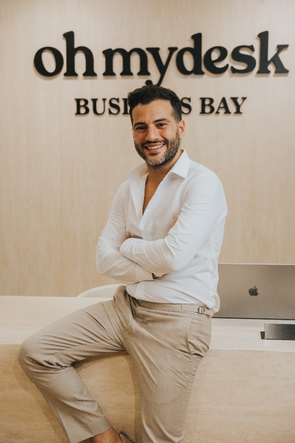 Guillaume Rassemi at the Oh My Desk Business Bay reception, arms crossed