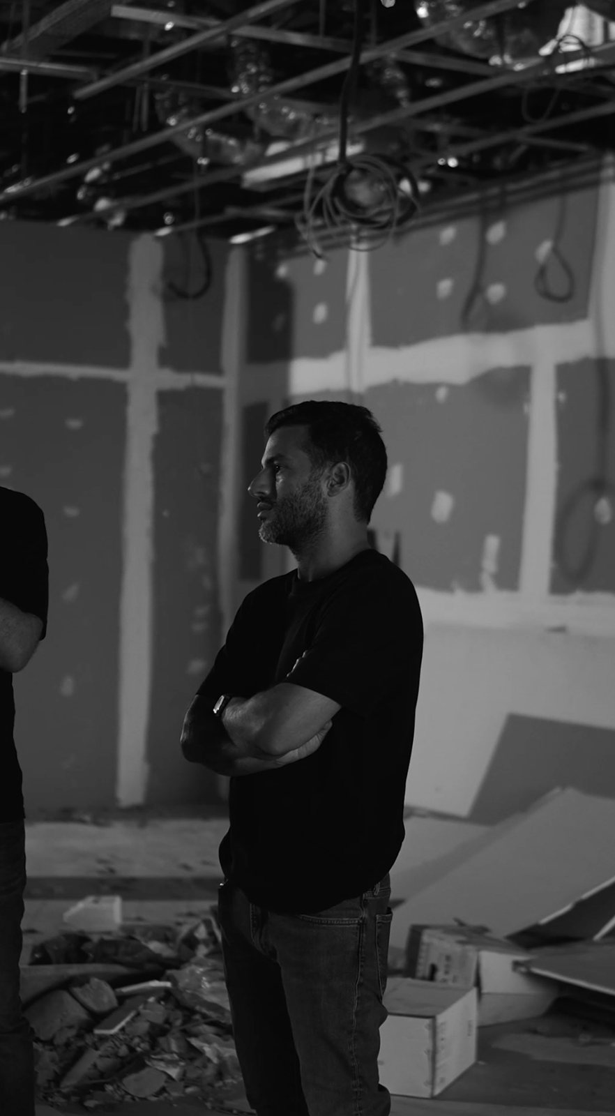 Guillaume Rassemi, arms crossed, on a construction site during the fit-out of an Oh My Desk space